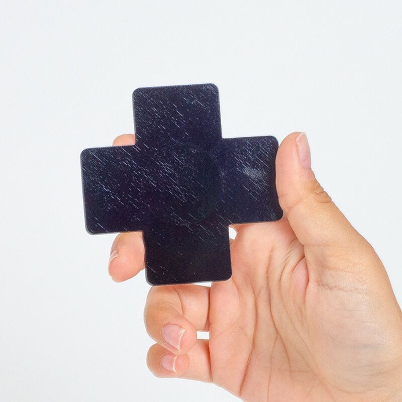 Close-up of SECRET PLAY Protetores de Mamilo Cruz Holográfica, 2 Pares, showing the black and pink designs.