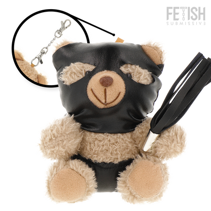 Urso de Pelúcia BDSM Luno da FETISH SUBMISSIVE com máscara preta e chicote, detalhes de arreios e correntes.